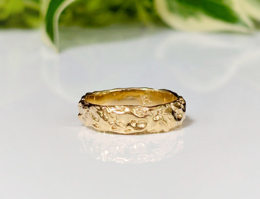Handcrafted Molten Gold Wedding Ring with textured rustic design, showcasing organic beauty and modern elegance.