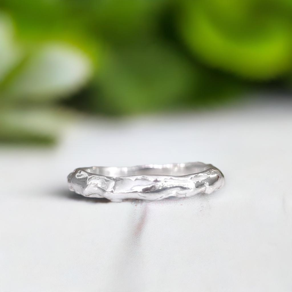 Molten Silver textured wedding band with an abstract, irregular design, handcrafted in solid sterling silver.