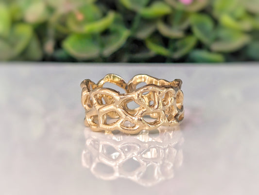 Molten Gold Honeycomb ring in solid 14k gold showcasing unique abstract design and fluid metal form.
