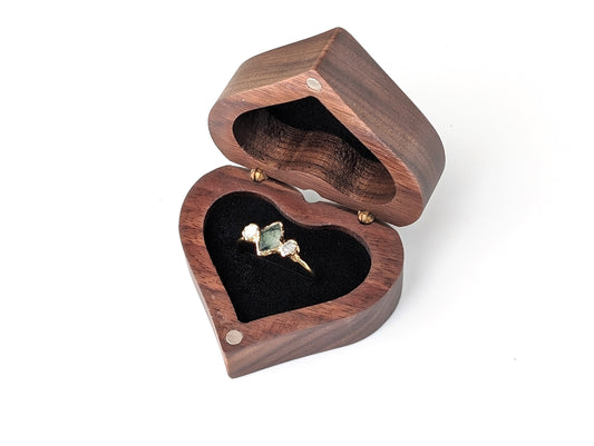 Heart-shaped wooden ring gift box with a gold ring inside, perfect for jewelry gifts.