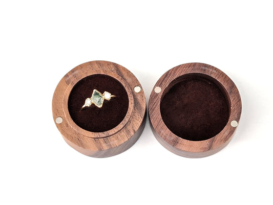 Wooden ring gift box with a gold and gemstone ring displayed inside, featuring a lovely walnut finish.