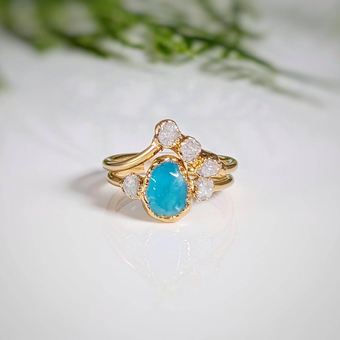 Raw Peruvian Opal and diamond engagement ring set with gold bands, showcasing unique aqua-blue stone and sparkling diamonds.