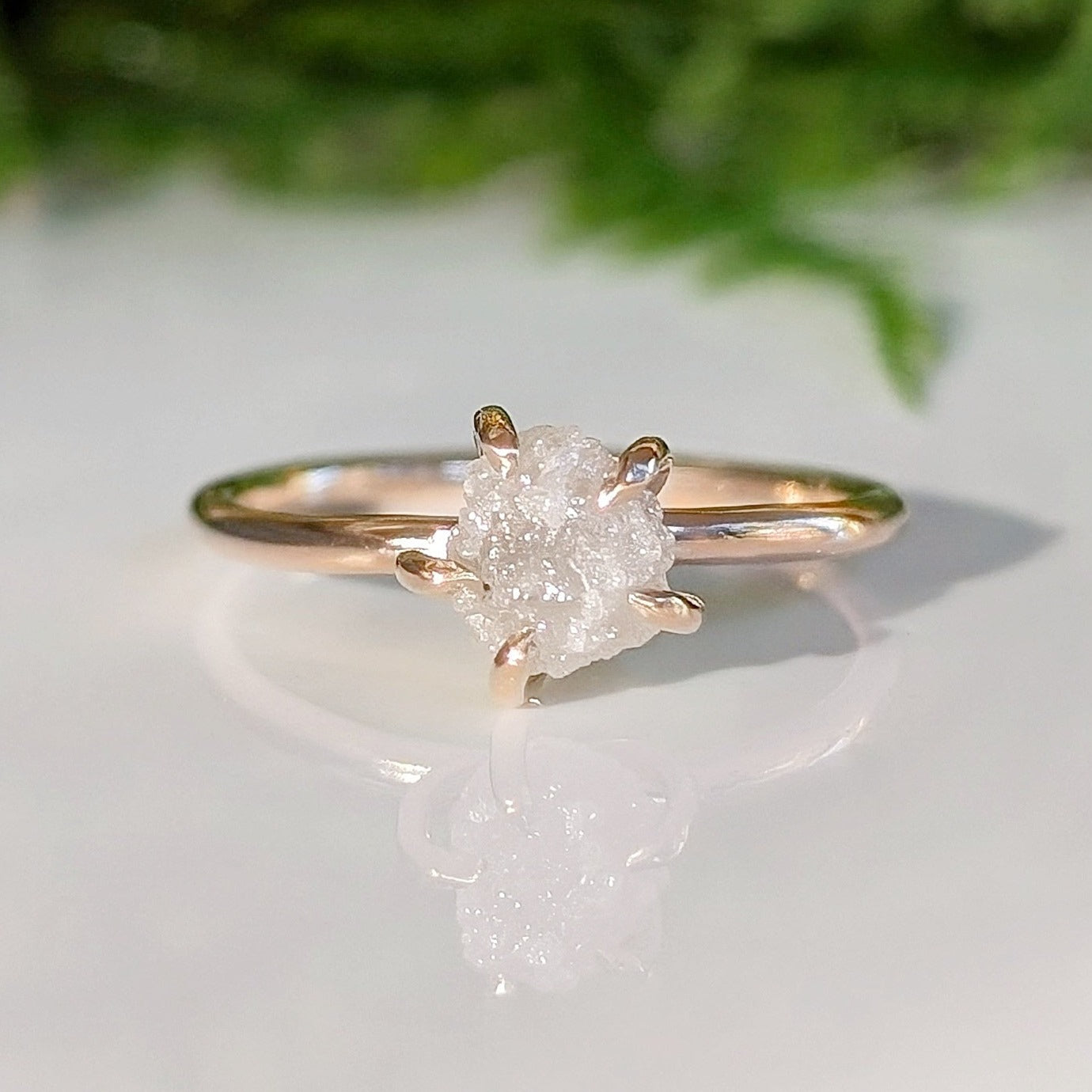 Raw diamond engagement ring in recycled gold, showcasing unique, uncut diamond craftsmanship.