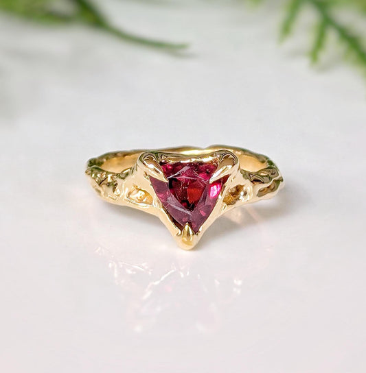 Rubellite Tourmaline textured ring in solid 14k gold with an organic band and a striking dark pink gemstone.
