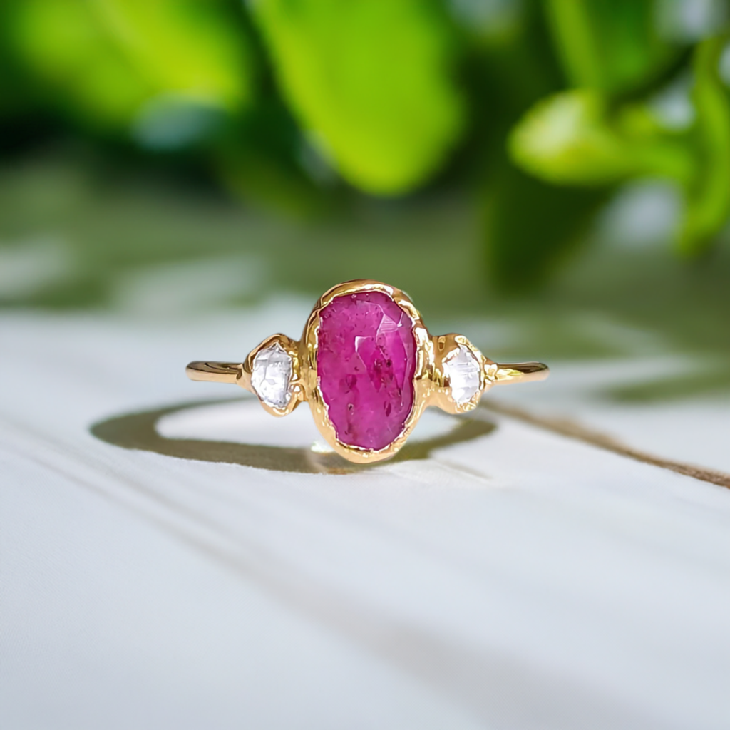 Stunning Rubellite Tourmaline and diamond engagement ring on a delicate gold band.