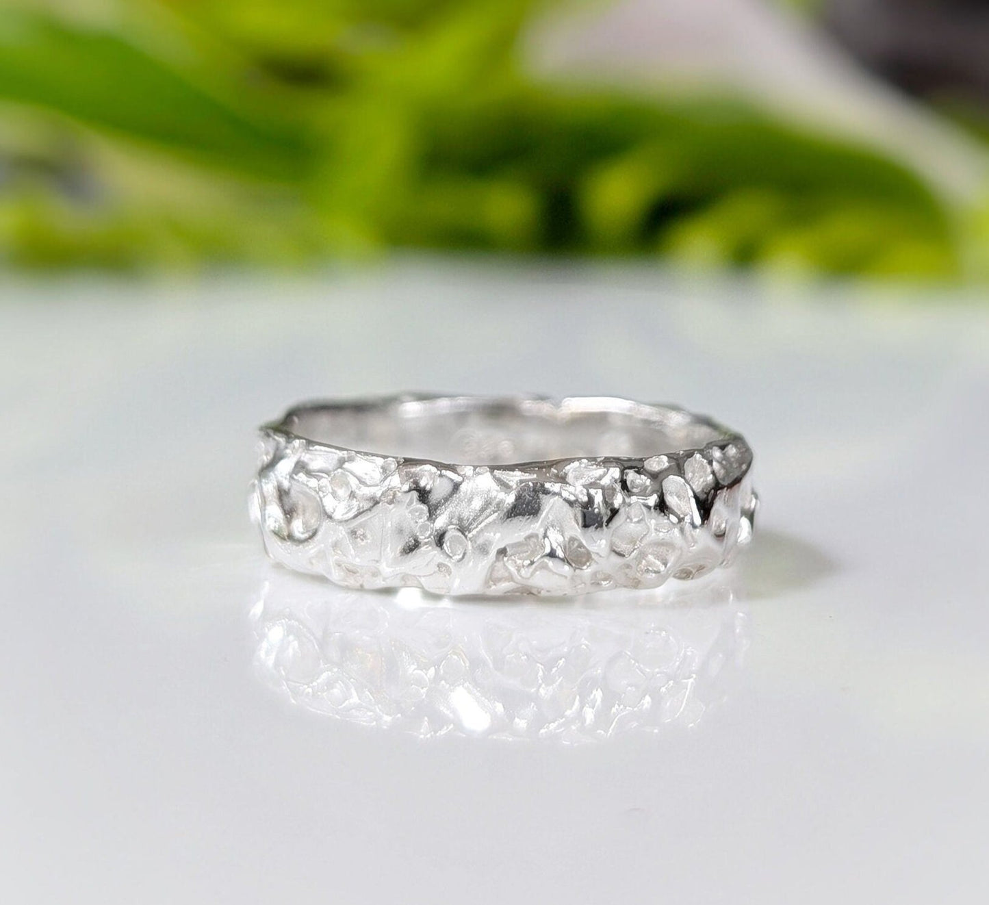 Textured handcrafted molten gold wedding ring showcasing rustic elegance and organic design.