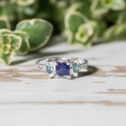 Blue Sapphire and Tourmaline engagement ring in solid sterling silver, handcrafted with a textured design.