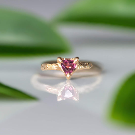 Rubellite Tourmaline engagement ring in solid 14k gold with organic textured band and trilliant shape stone.