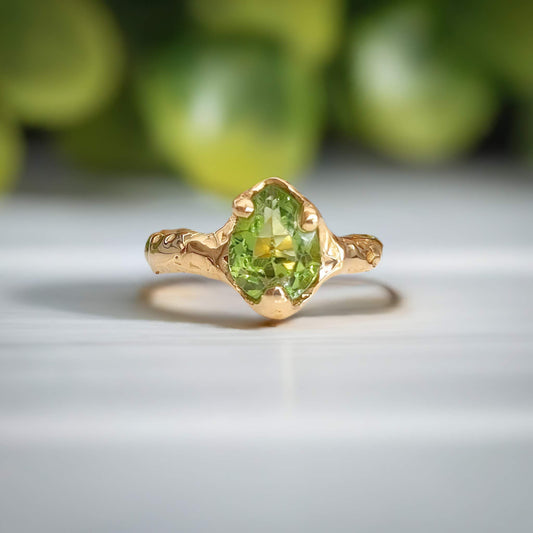 Unique handcrafted Peridot ring set in solid 14k gold with organic textured band, perfect for August birthdays.
