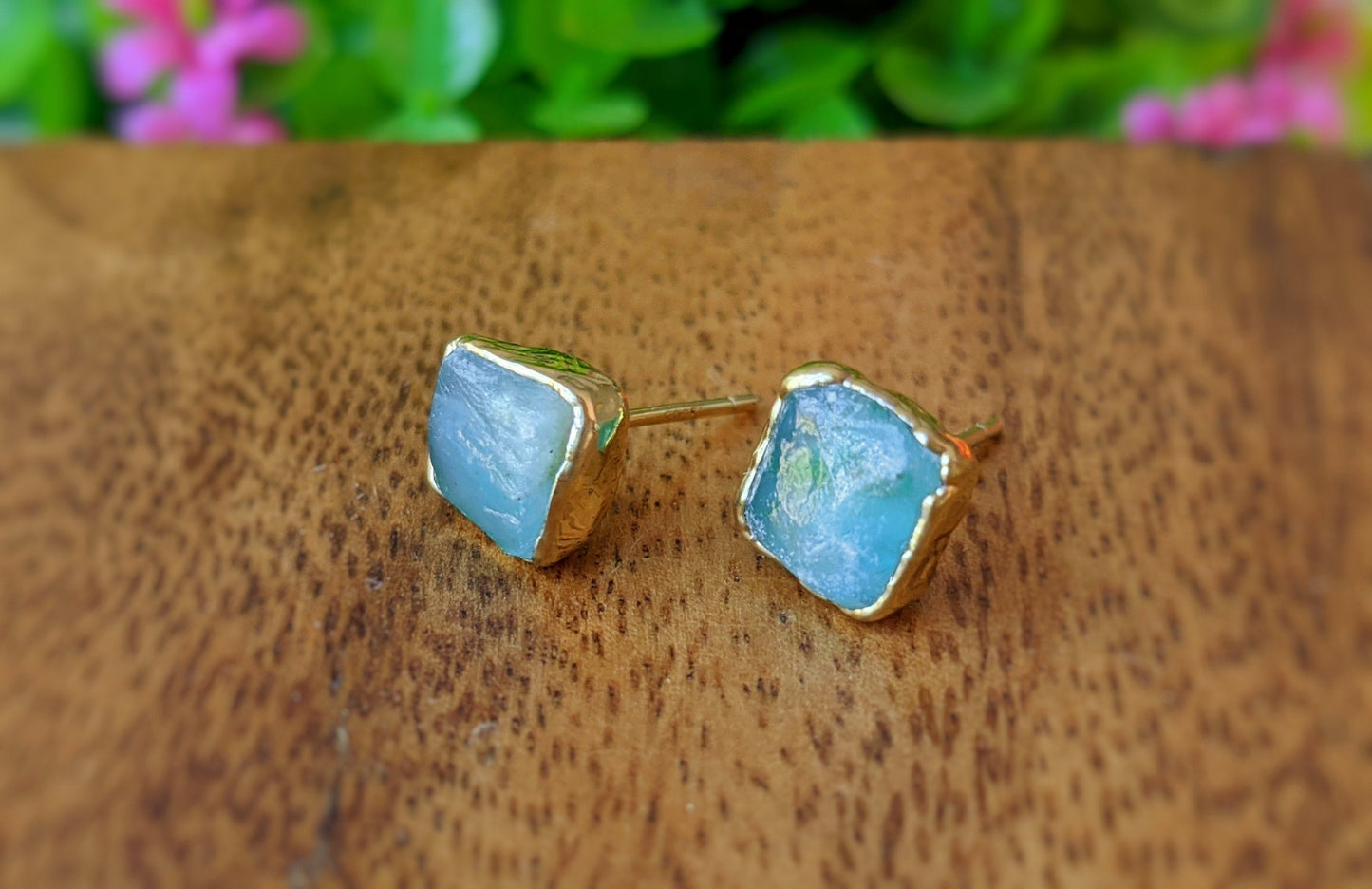 Raw Peruvian Opal stud earrings with gold setting, showcasing aquas and blues reminiscent of the ocean.