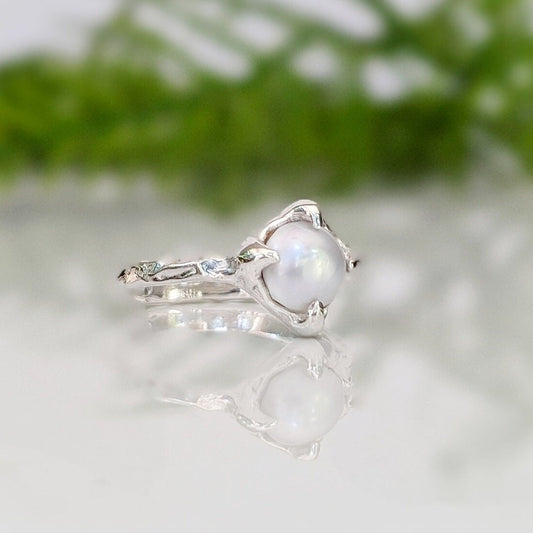 Silver textured ring featuring a creamy-white Freshwater Keshi pearl, perfect for simplicity and elegance.