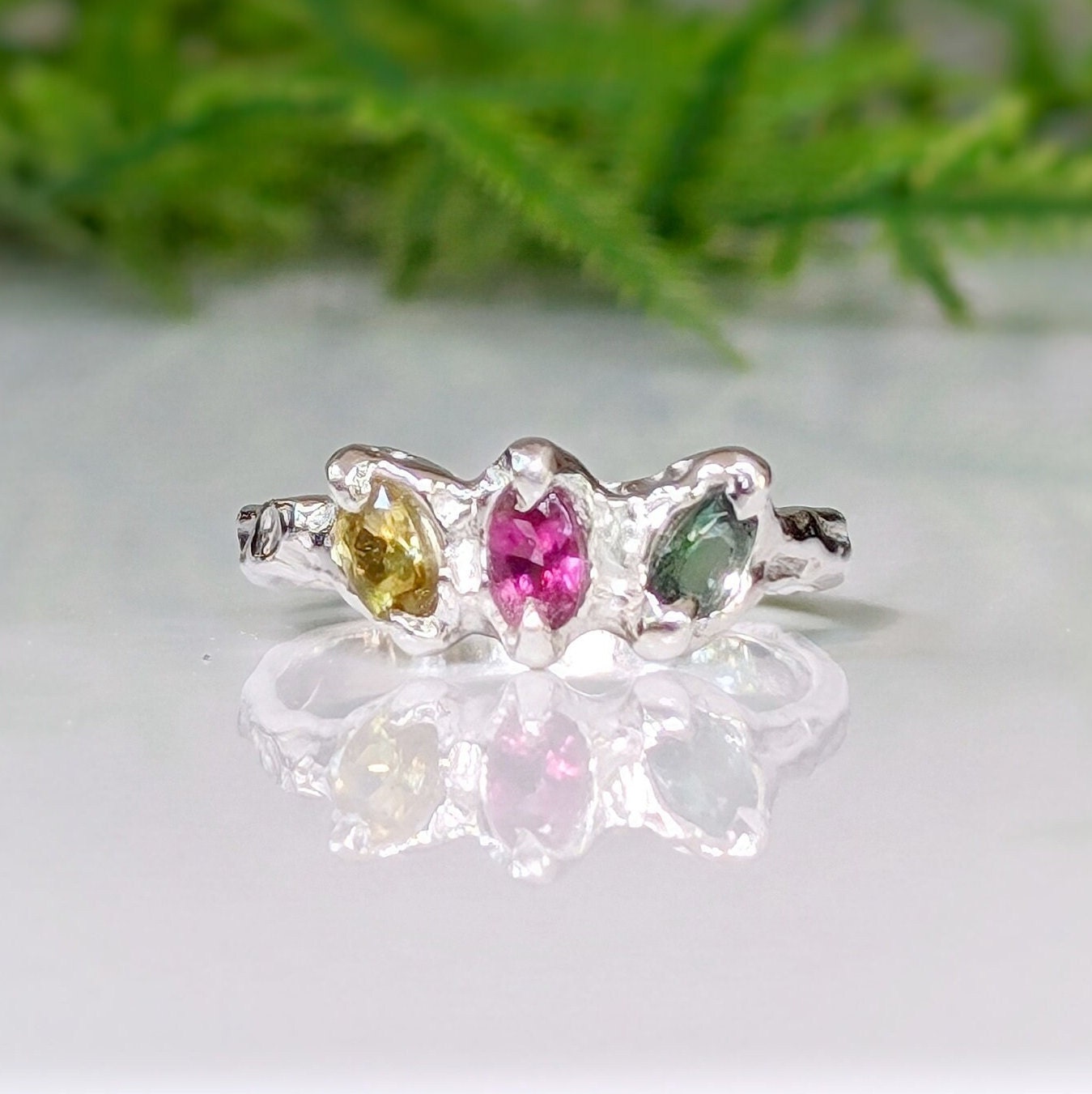 Solid gold multi Tourmaline ring with three colorful stones set in a unique silver design.