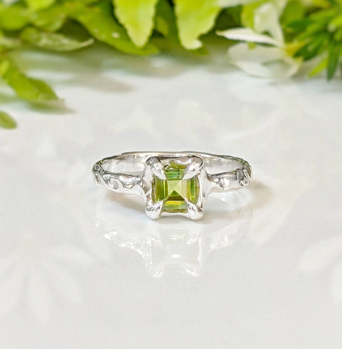 Solid 14k Gold ring featuring a princess-cut Peridot, handcrafted with an organic textured band, symbolizing love.
