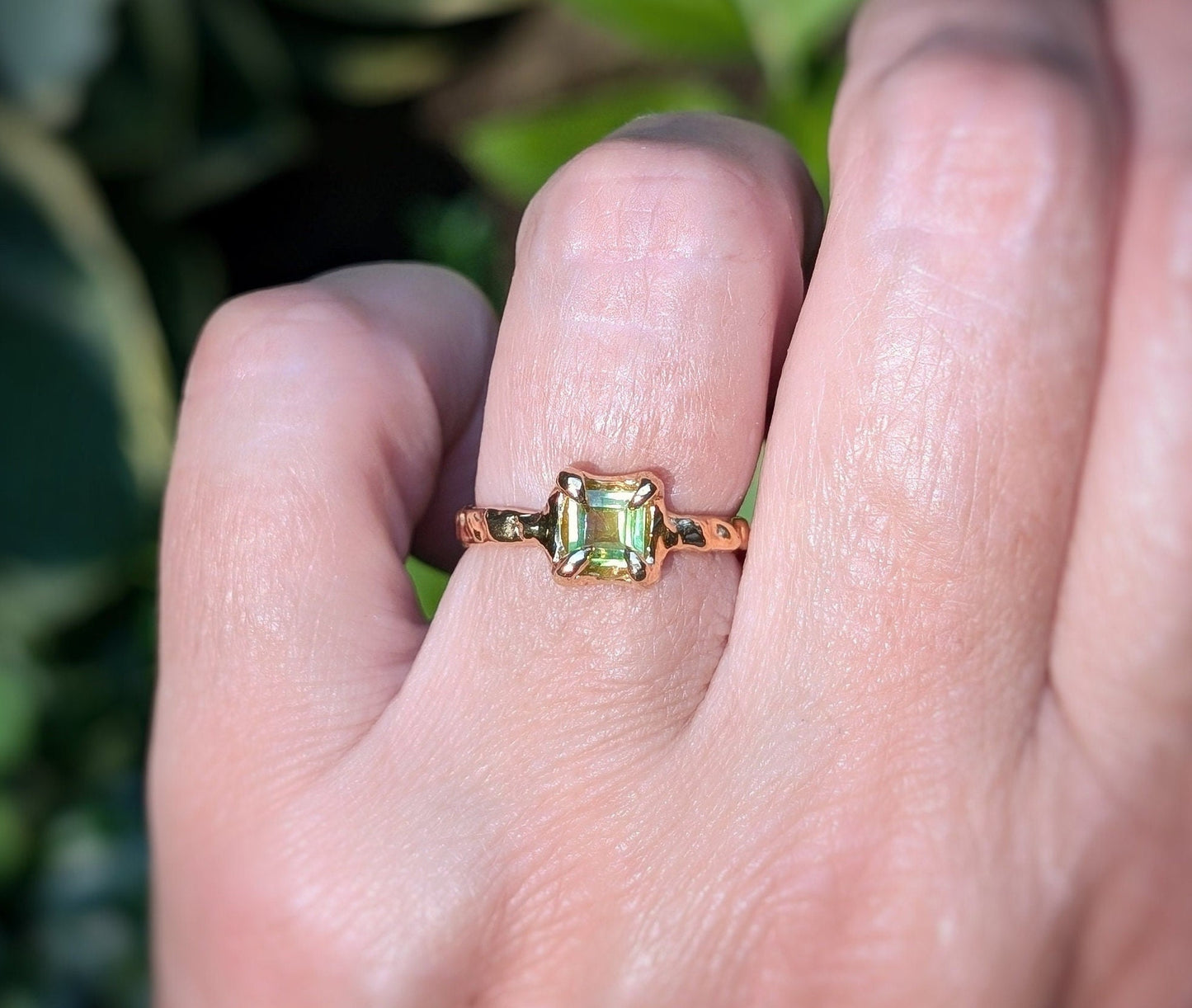 Solid silver ring featuring a princess-cut Peridot on a textured band, showcasing elegance and individuality.