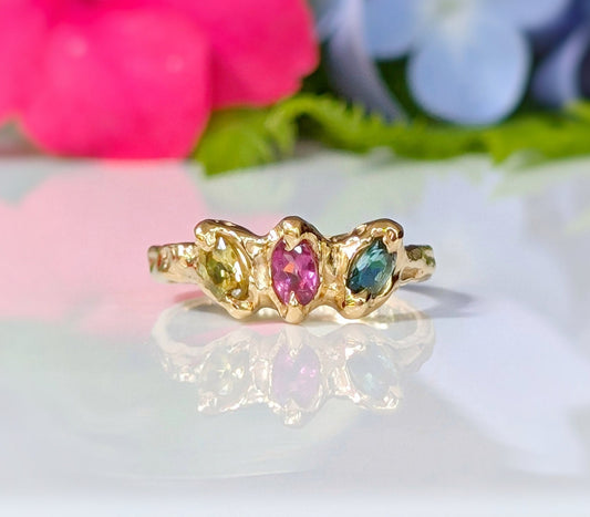 Solid gold multi Tourmaline ring featuring three colorful gemstones in a unique organic design.