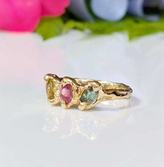 Solid gold multi Tourmaline ring featuring three colorful gemstones set in organic design, perfect for a promise or engagement ring.