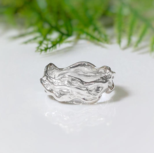 Handcrafted sterling silver molten textured ring, featuring an abstract liquid metal design, perfect for unique weddings.