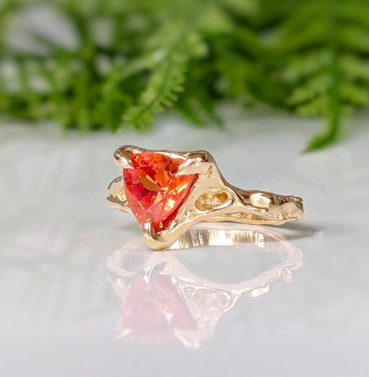 Orange Sapphire trilliant cut ring in solid 14k gold with textured band, showcasing unique handcrafted design.