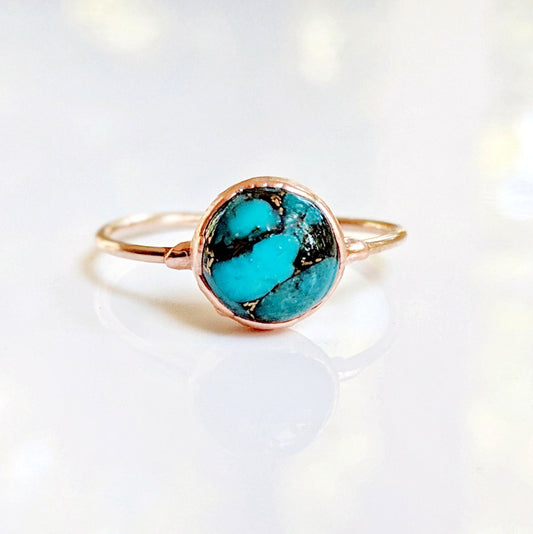 Natural Turquoise ring featuring a round 10mm stone on a delicate 14k gold filled band, showcasing unique color variations.
