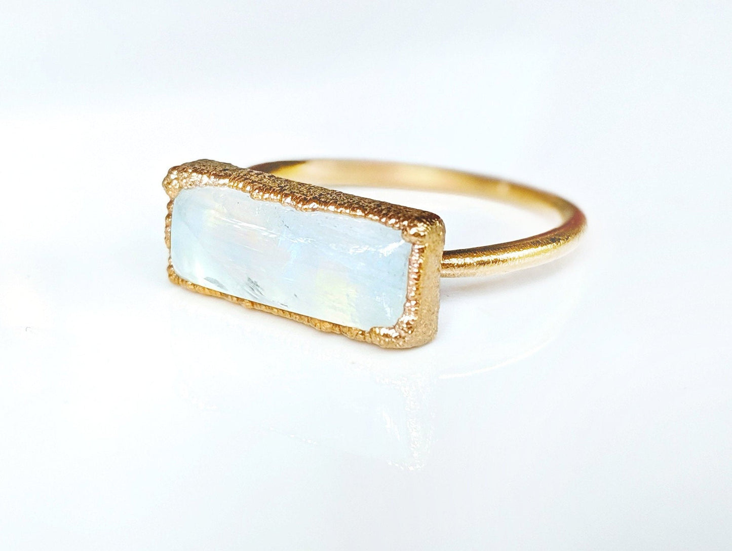 Natural rainbow Moonstone ring with 14k gold filled band, symbolizing new beginnings and feminine energy.