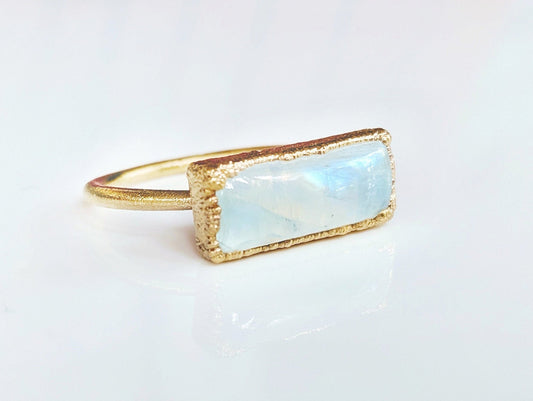 Natural rainbow Moonstone ring set in 14k gold filled band, symbolizing new beginnings and feminine energy.