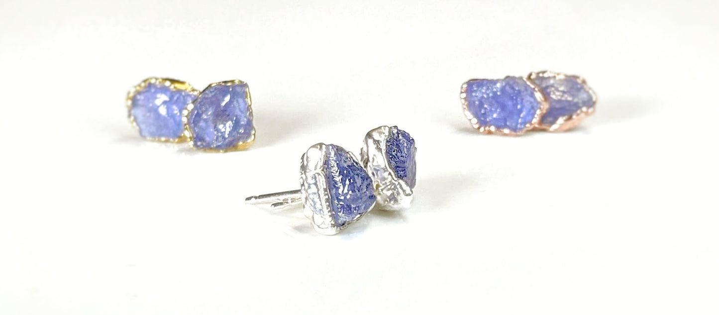 Handcrafted raw Tanzanite stud earrings on silver posts, featuring unique electroformed designs in various colors.