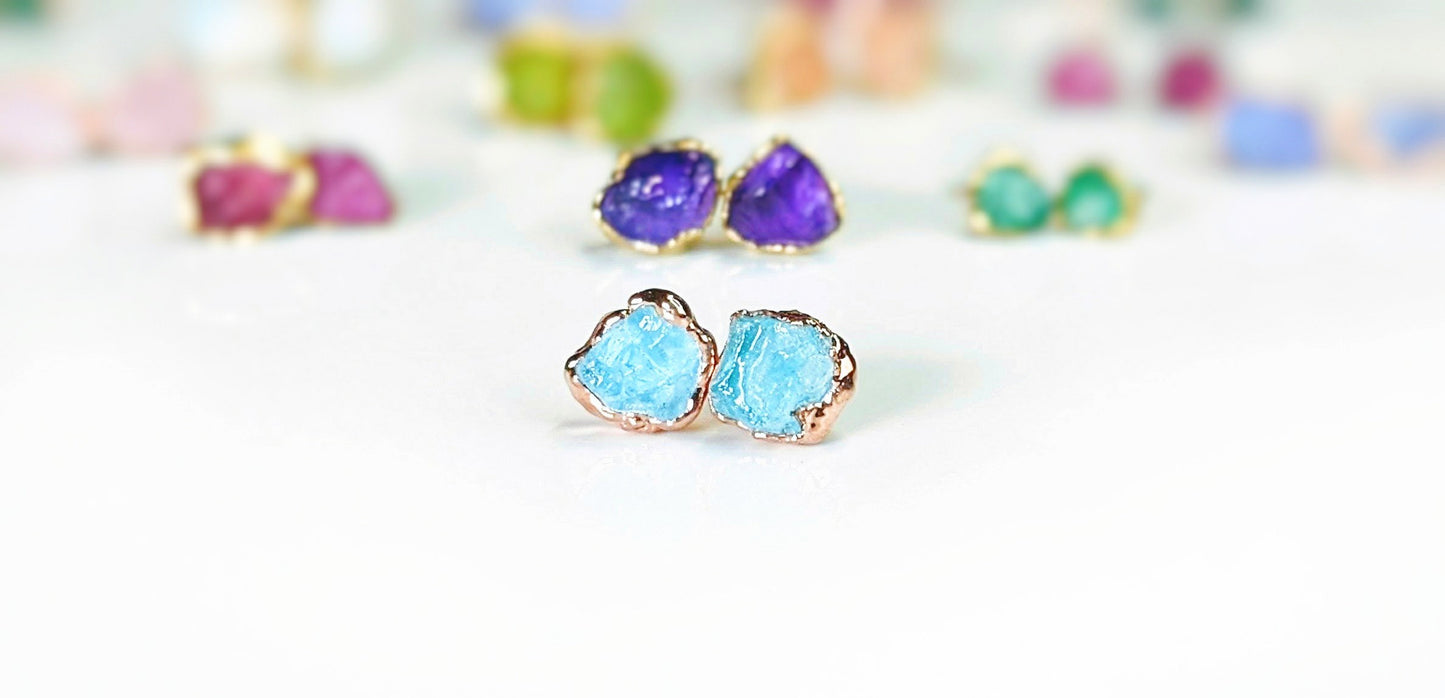 Raw Aquamarine stud earrings set in 18k gold, showcasing unique rough gemstones, perfect for March birthdays.