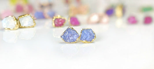 Handcrafted raw Tanzanite stud earrings with gold accents, showcasing December birthstone elegance.