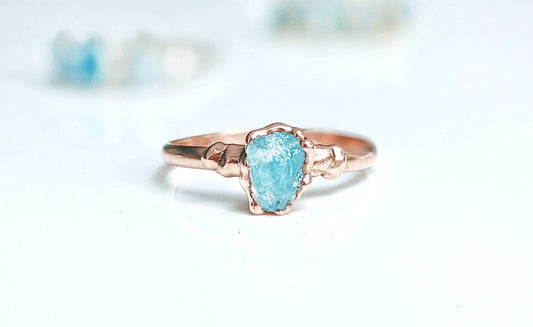Raw Aquamarine ring on a rose gold band, featuring a unique electroformed design. Perfect for March birthdays.