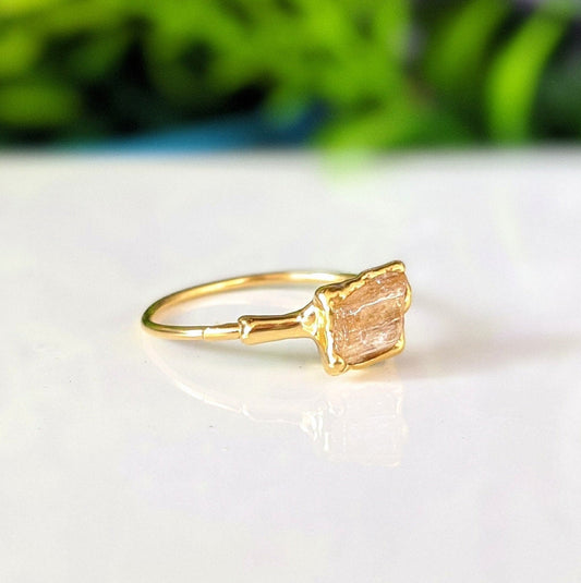 Handmade raw Imperial Topaz ring on 18k gold band, featuring a honey-colored gemstone, perfect for November birthdays.