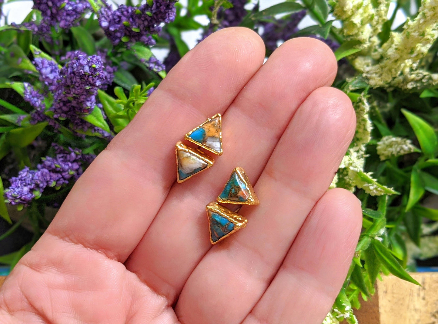Spiny oyster copper turquoise stud earrings in hand, featuring triangular stones set on gold-filled posts.