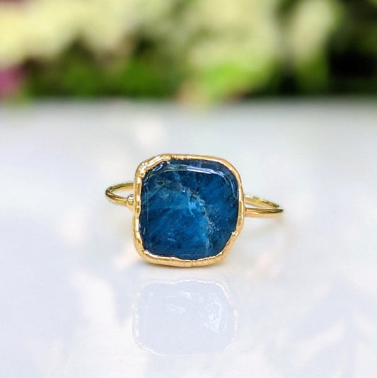 Natural blue Apatite ring set in gold, featuring a raw stone design and elegant band, perfect for unique jewelry lovers.