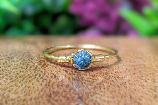 Raw blue diamond engagement ring on solid 18k gold band, handcrafted for unique elegance and perfect for Valentine's Day.