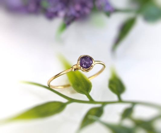 Dainty gold stacking ring with a 4mm natural purple Amethyst gemstone, perfect for minimalist jewelry lovers.