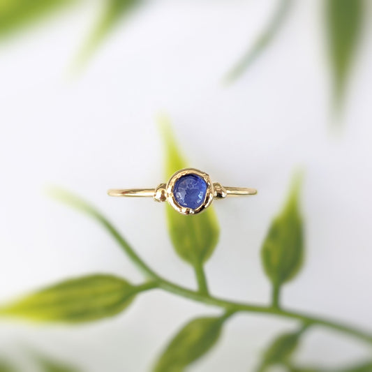 Dainty sapphire stacking ring with a 4mm natural blue sapphire gemstone on a gold filled band.