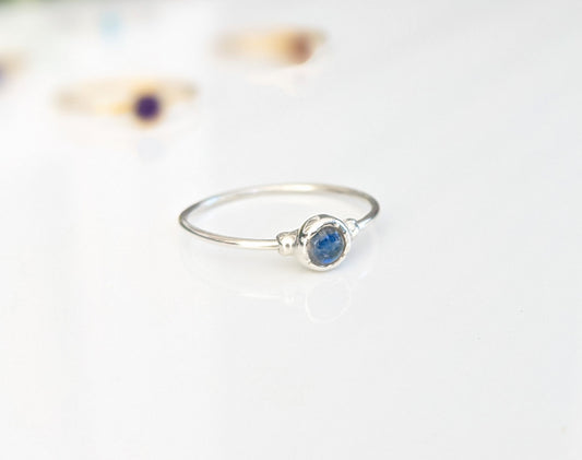 Dainty silver ring featuring a natural blue gemstone, perfect for stacking or as a minimalist everyday piece.