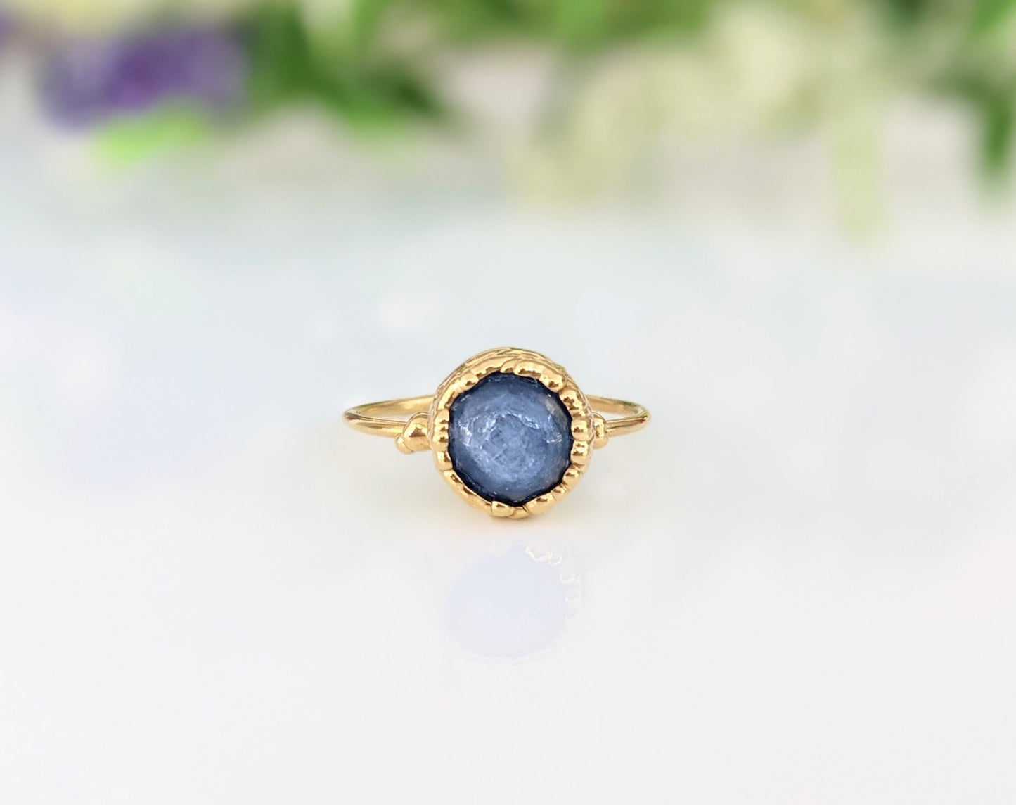 Close-up of a blue Kyanite ring set in an 18k gold-plated band, showcasing its natural beauty and unique design.