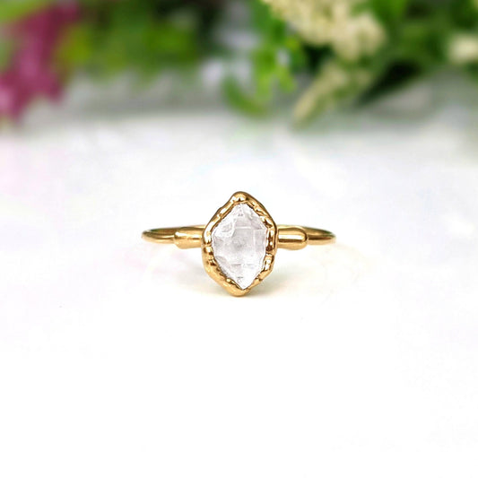 Gold Herkimer diamond engagement ring with raw diamond in a delicate setting.