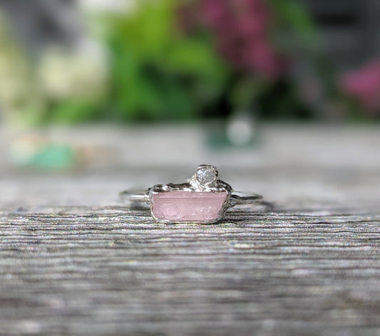 Raw pink tourmaline and rough diamond engagement ring, handcrafted with rustic charm and elegance.