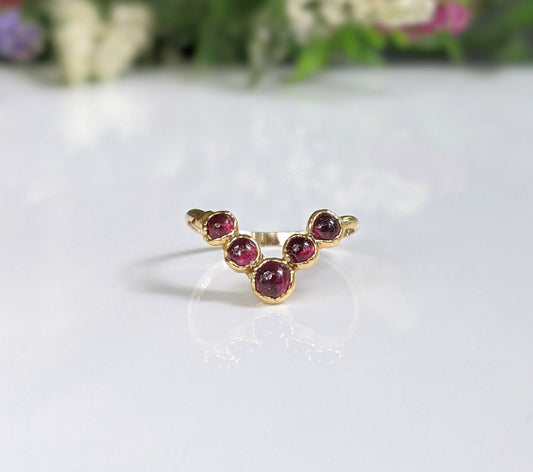 Ruby chevron ring in 18k gold showcasing natural red rubies, perfect for weddings or anniversaries.