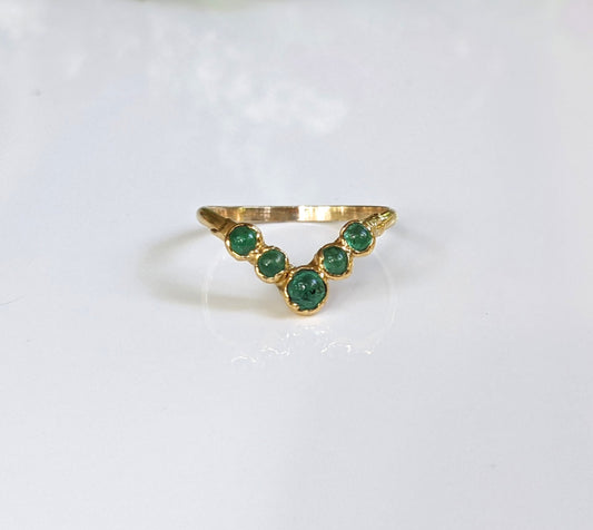 Natural Emerald Chevron wedding ring in 18k Gold with five green emeralds, perfect for anniversaries or special gifts.
