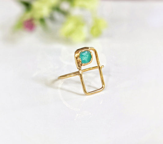 Raw Peruvian opal geometric ring with a natural blue opal set in a rectangular 14k gold band.