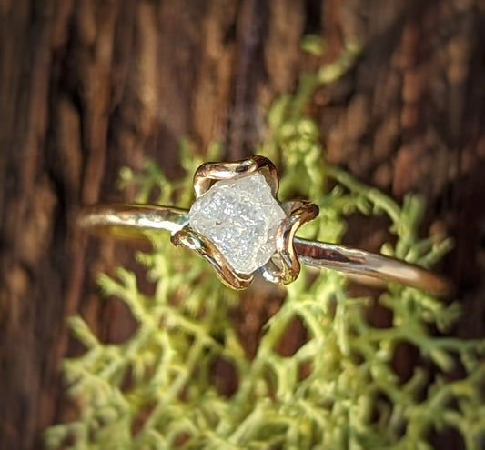 Unique raw diamond flower prong engagement ring on gold band, featuring a rustic and elegant design.