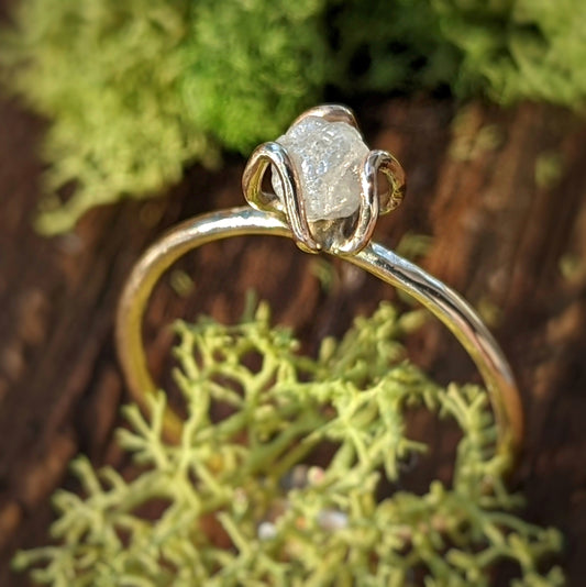 Handcrafted raw diamond flower prong engagement ring on a 14k gold band, perfect for a unique proposal.