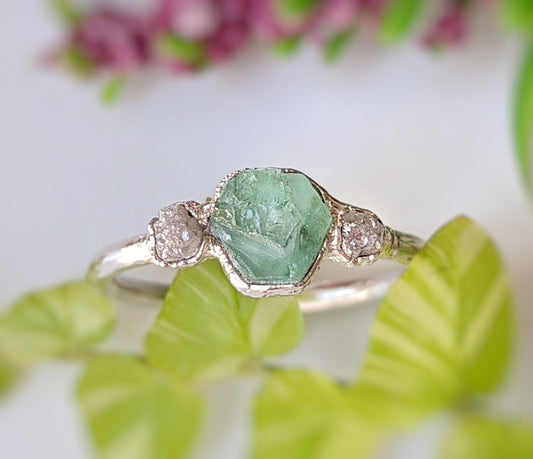 Raw emerald and rough diamond engagement ring, uniquely handcrafted with rustic charm and elegance.