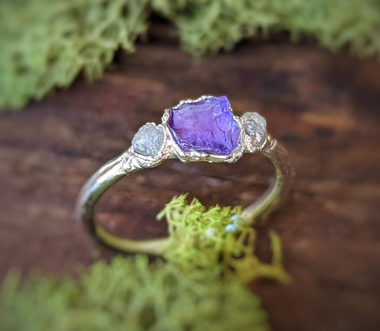 Raw Amethyst and rough diamond ring on a natural backdrop, handcrafted sterling silver with a unique design.