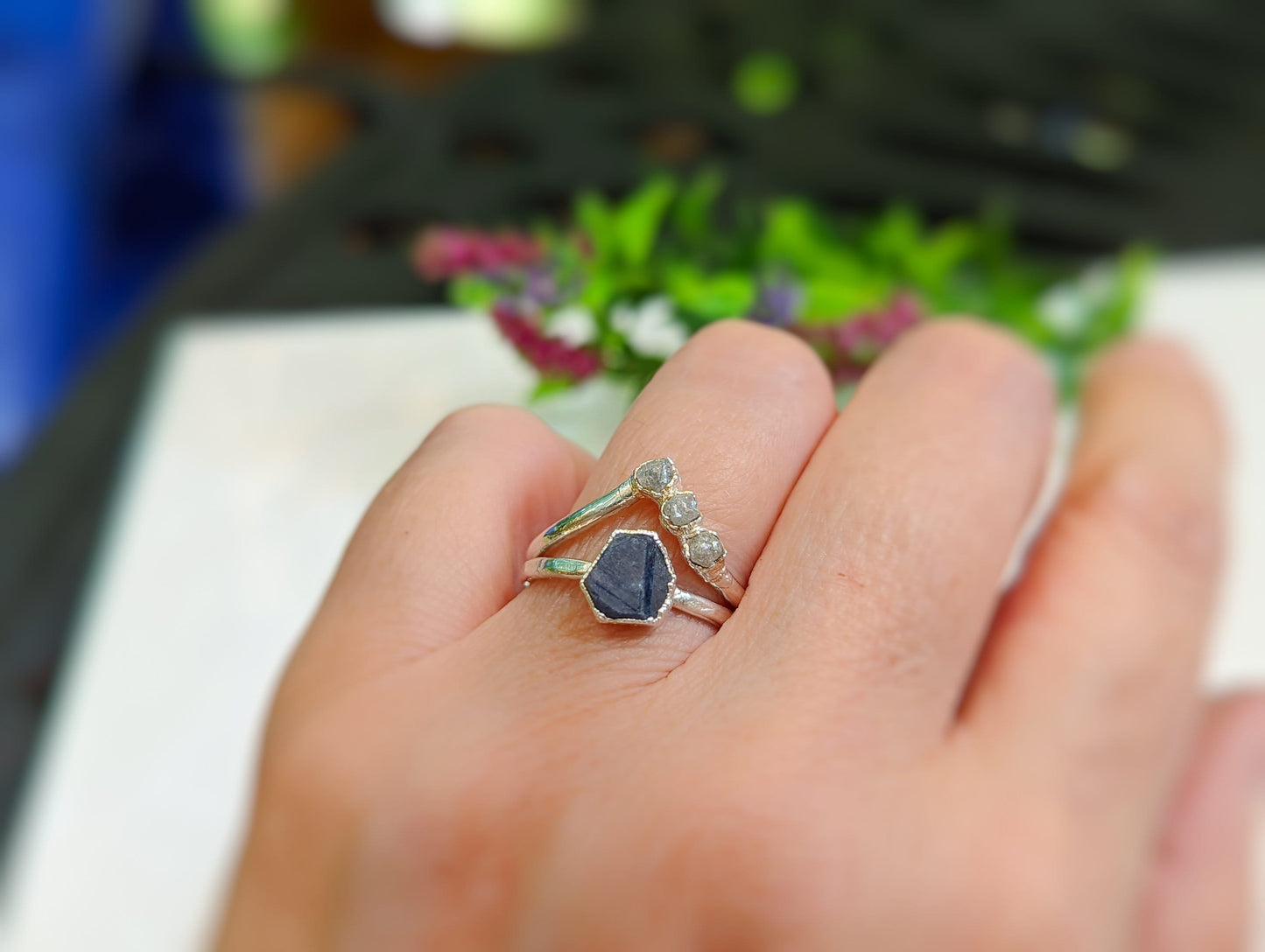 Raw sapphire and diamond chevron wedding ring set on hand, crafted in solid 14k gold with a rustic design.