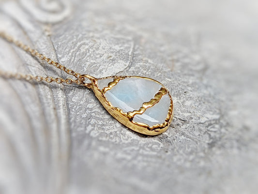 Kintsugi necklace featuring pear-shaped rainbow moonstone, electroformed with 18k gold plating on a gold-filled chain.