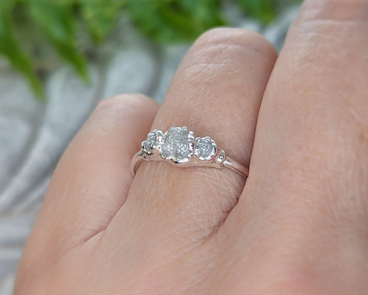 Handcrafted raw diamond engagement ring featuring a large raw diamond and two smaller raw diamonds.