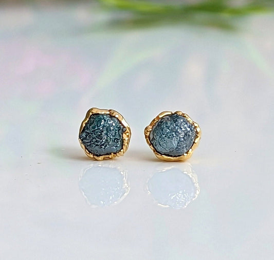 Unique raw blue diamond stud earrings with gold settings, perfect for elevating bridal and casual looks.
